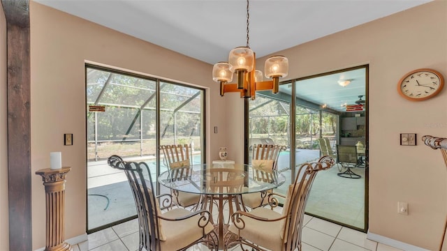 dining area with a notable chandelier, baseboards, and a sunroom