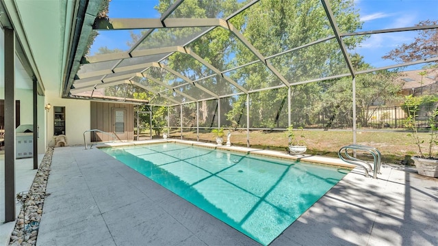 pool with glass enclosure and a patio