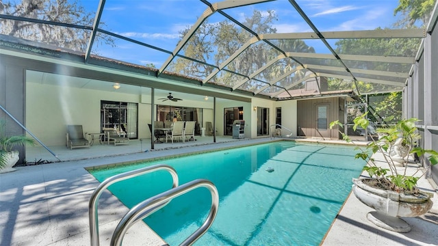 outdoor pool featuring a patio, a lanai, and a ceiling fan