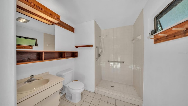 full bathroom with tile patterned floors, toilet, vanity, and a tile shower