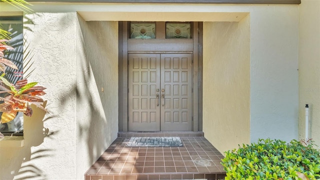 doorway to property with stucco siding