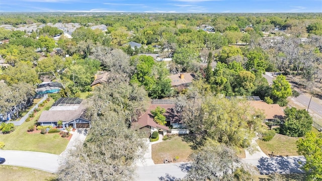 birds eye view of property featuring a forest view