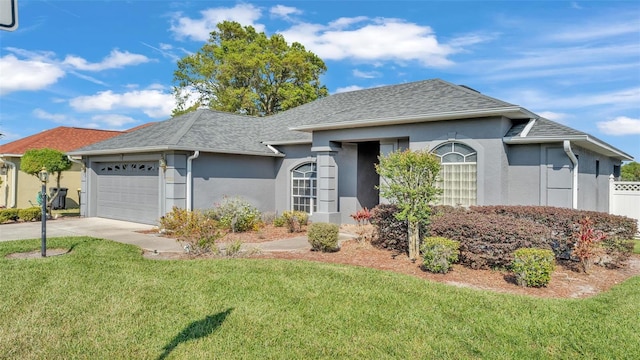 ranch-style house featuring a front lawn, an attached garage, driveway, and stucco siding