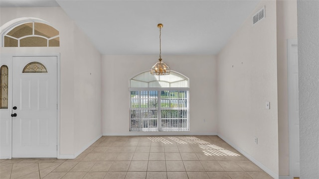 entrance foyer with light tile patterned flooring, baseboards, visible vents, and a chandelier