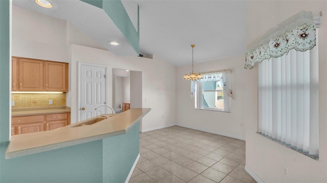 kitchen with light brown cabinets, a sink, light tile patterned floors, decorative backsplash, and vaulted ceiling