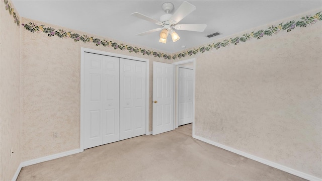 unfurnished bedroom with visible vents, baseboards, ceiling fan, carpet floors, and a closet