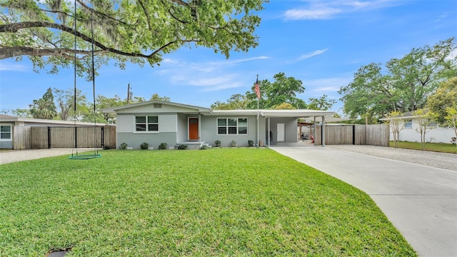 ranch-style home with concrete driveway, a carport, fence, and a front lawn