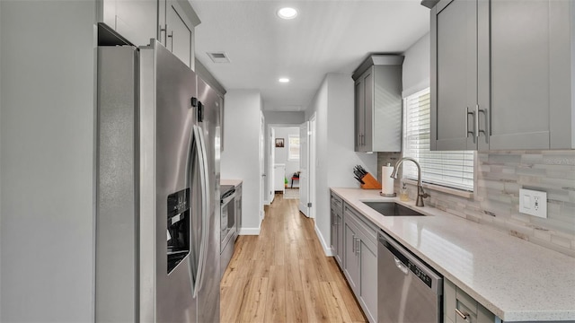 kitchen featuring a sink, visible vents, appliances with stainless steel finishes, and gray cabinetry