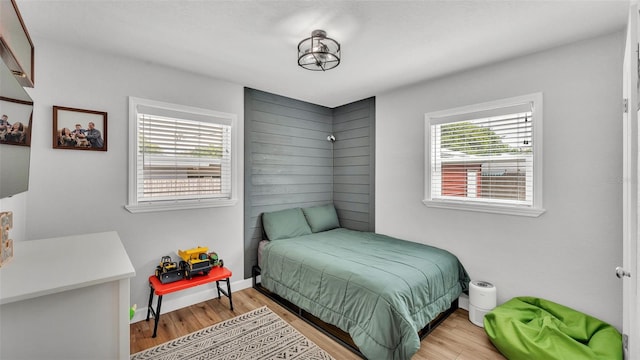 bedroom featuring wood finished floors and baseboards