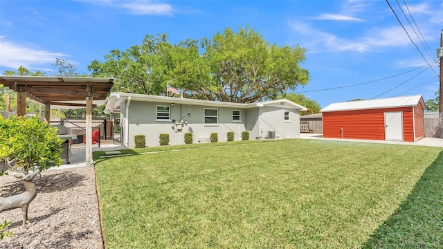 rear view of house with an outbuilding, a patio, fence, a yard, and central AC unit