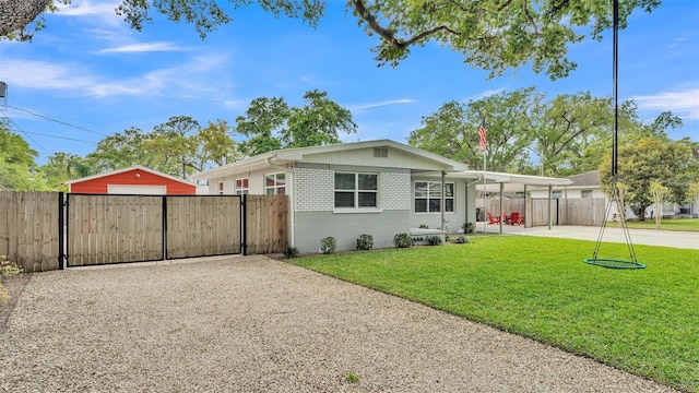 exterior space featuring driveway, fence, a front yard, and a gate