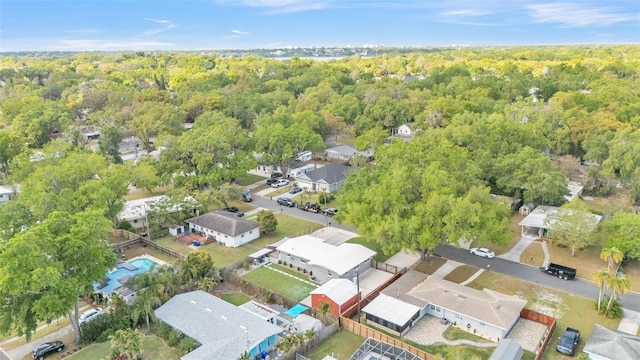 aerial view featuring a wooded view and a residential view