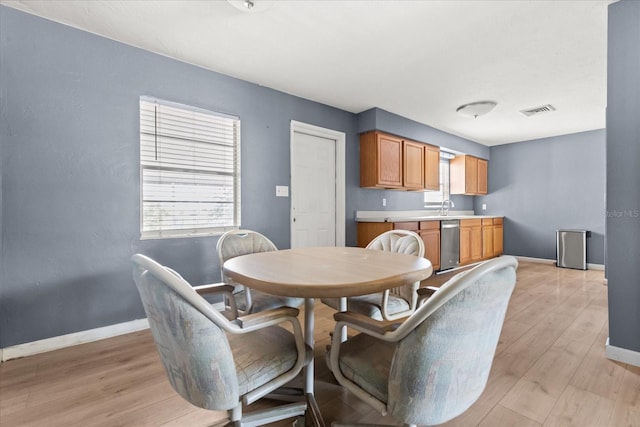 dining space with visible vents, baseboards, and light wood finished floors