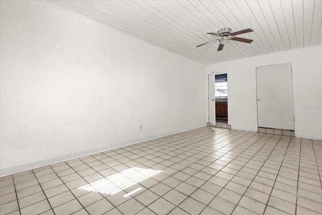 unfurnished room with wooden ceiling, baseboards, light tile patterned flooring, and a ceiling fan