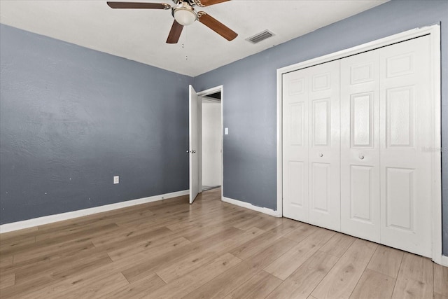 unfurnished bedroom with visible vents, baseboards, light wood-type flooring, a closet, and a ceiling fan