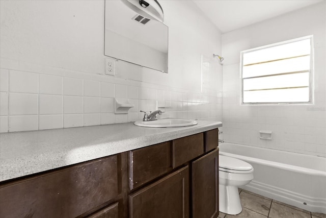 bathroom with vanity, visible vents, tile patterned flooring, tile walls, and toilet