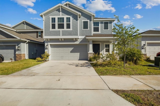 craftsman-style home with stucco siding, driveway, a front yard, and a garage