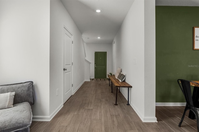 corridor featuring recessed lighting, baseboards, and wood finished floors