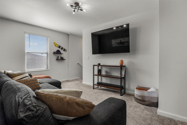 carpeted living room with baseboards and a textured ceiling