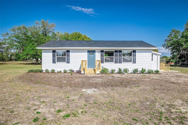 single story home featuring roof with shingles