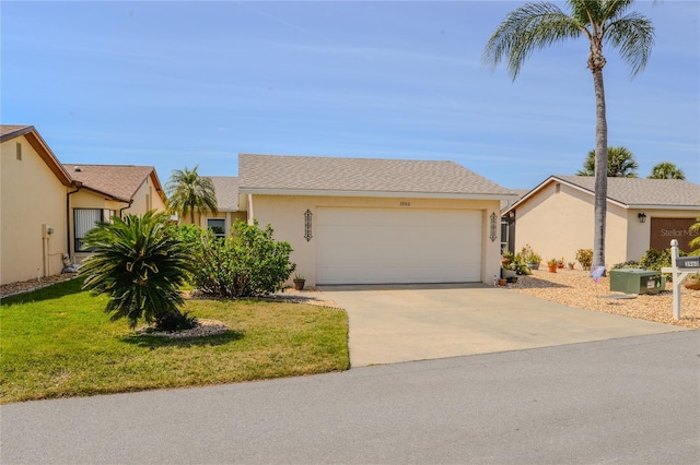 view of front of home featuring concrete driveway, an attached garage, a front lawn, and stucco siding