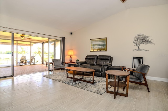 living area with vaulted ceiling and baseboards