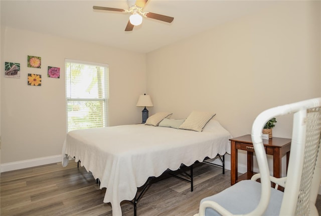 bedroom with wood finished floors, baseboards, and ceiling fan