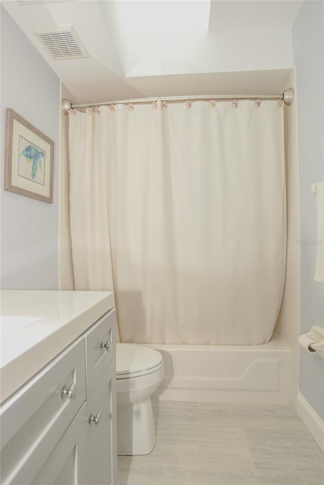 bathroom featuring visible vents, vanity, toilet, and shower / tub combo