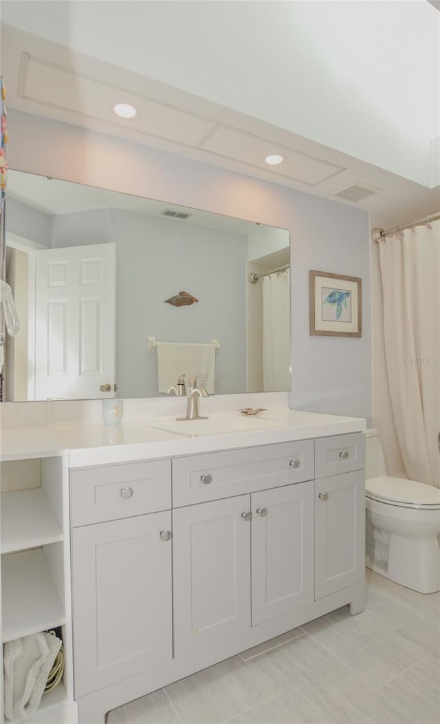 bathroom with vanity, toilet, recessed lighting, and visible vents