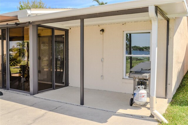 doorway to property featuring stucco siding and a patio