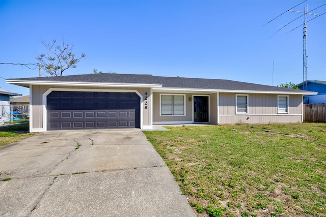 ranch-style home with a front yard, fence, a garage, and driveway