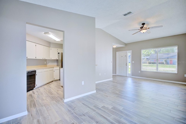 unfurnished living room with a ceiling fan, visible vents, light wood finished floors, and baseboards