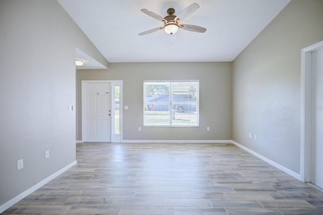 entrance foyer featuring light wood-type flooring, baseboards, a textured ceiling, and ceiling fan