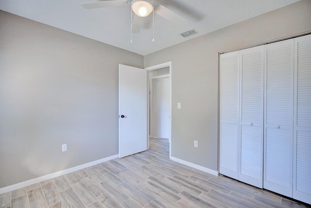 unfurnished bedroom with visible vents, baseboards, ceiling fan, light wood-style flooring, and a closet