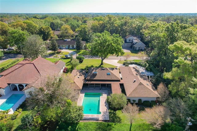 bird's eye view with a wooded view