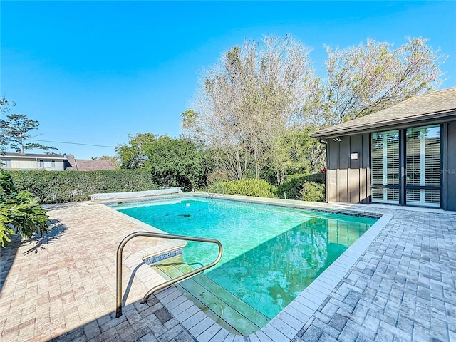 view of swimming pool with a fenced in pool and a patio