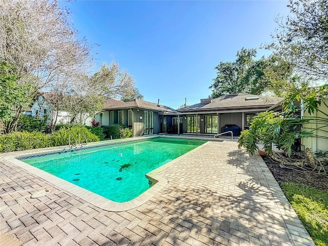 outdoor pool featuring a patio