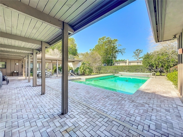 view of swimming pool featuring a fenced in pool, fence, and a patio area