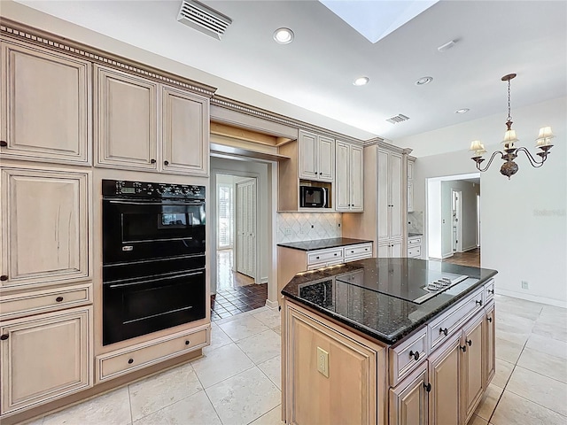 kitchen with visible vents, cream cabinets, black appliances, and an inviting chandelier