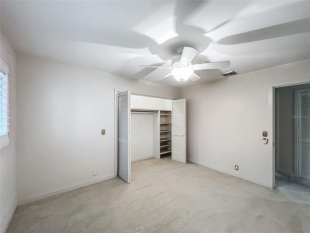 unfurnished bedroom with a closet, baseboards, visible vents, and a ceiling fan