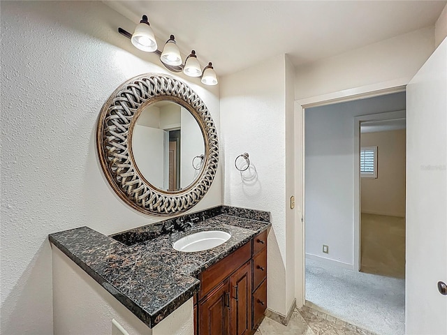 bathroom with baseboards and vanity