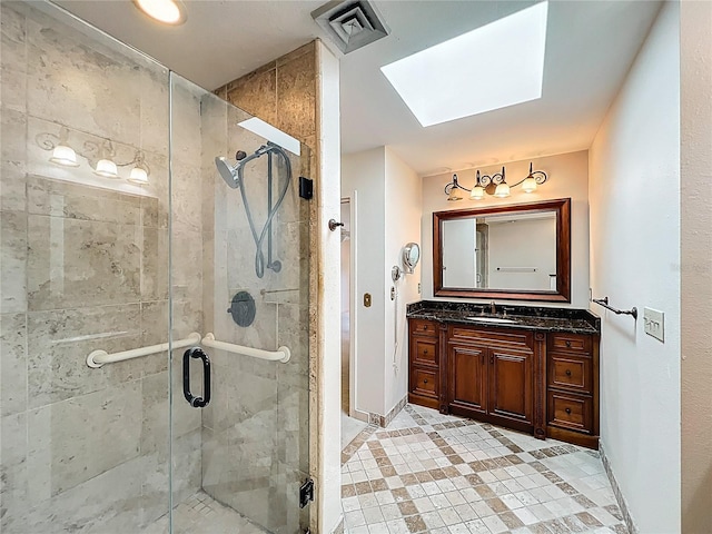 full bath featuring visible vents, a stall shower, a skylight, and vanity