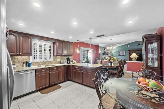 kitchen with visible vents, a sink, stainless steel dishwasher, backsplash, and light tile patterned floors