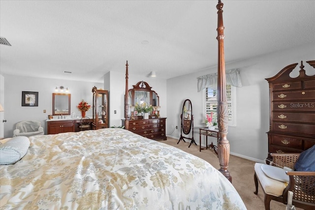 bedroom with light carpet, visible vents, a textured ceiling, and baseboards