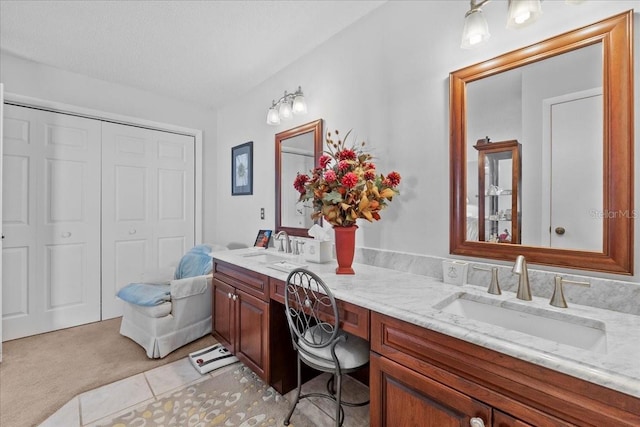 full bathroom with double vanity and a sink