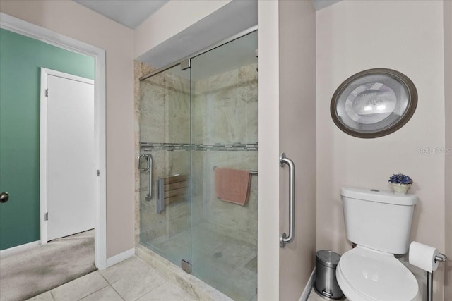 full bathroom with tile patterned floors, baseboards, toilet, and a stall shower
