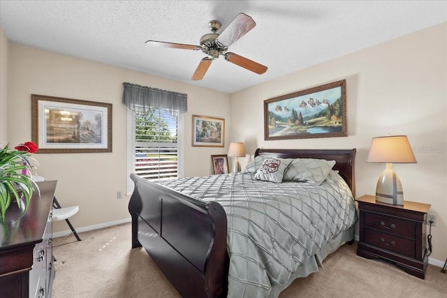 bedroom featuring light carpet, ceiling fan, a textured ceiling, and baseboards