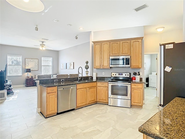 2420 Windchaser Ct, Melbourne, FL 32904 - kitchen featuring a peninsula, visible vents, ceiling fan, stainless steel appliances, and a sink