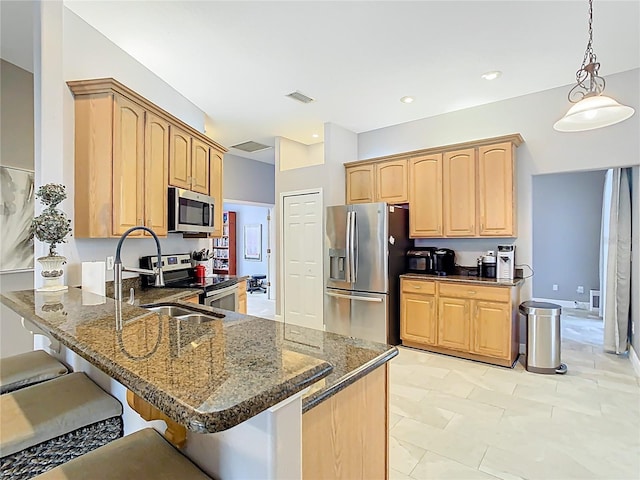 2420 Windchaser Ct, Melbourne, FL 32904 - kitchen with visible vents, appliances with stainless steel finishes, a kitchen breakfast bar, a peninsula, and light brown cabinetry