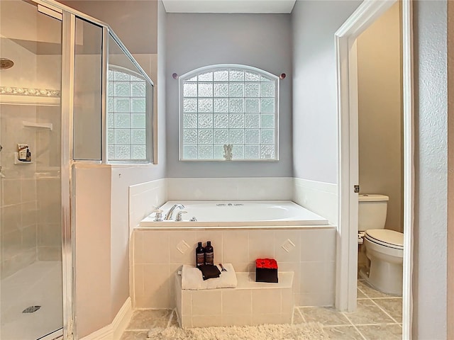 2420 Windchaser Ct, Melbourne, FL 32904 - bathroom featuring toilet, a bath, a stall shower, and tile patterned flooring